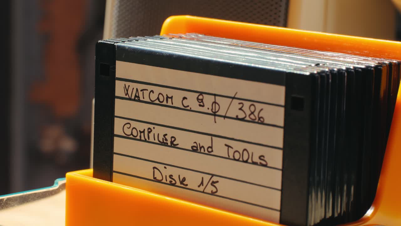 Using diskette for old computer. Music recorder, playing retro computer games. Vintage device for office, obsolete technology. . High quality 4k footage