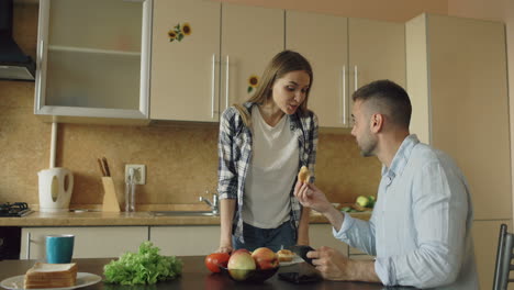 couple having breakfast in kitchen