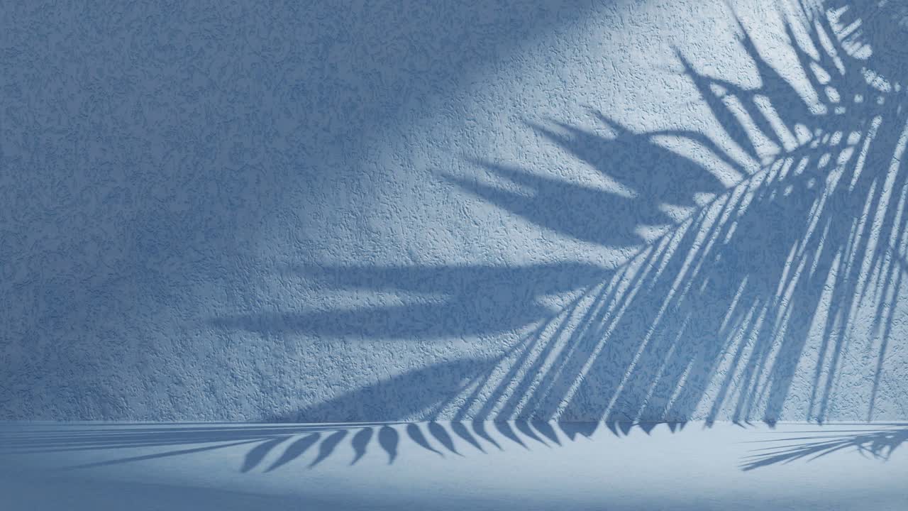 Blue textured wall with palm frond shadow waving in wind on back