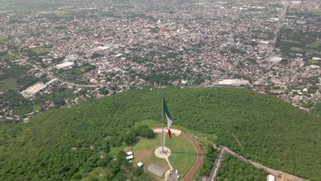 Flying-Towards-A-Mexican-Flag-Iguala,-Guerrero,-Mexico