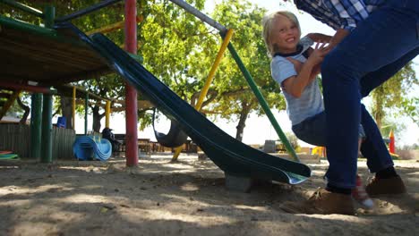 father and son playing in the playground 4k