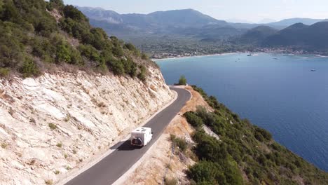 motorhome drives coastal road at lefkada, greece - dolly follow