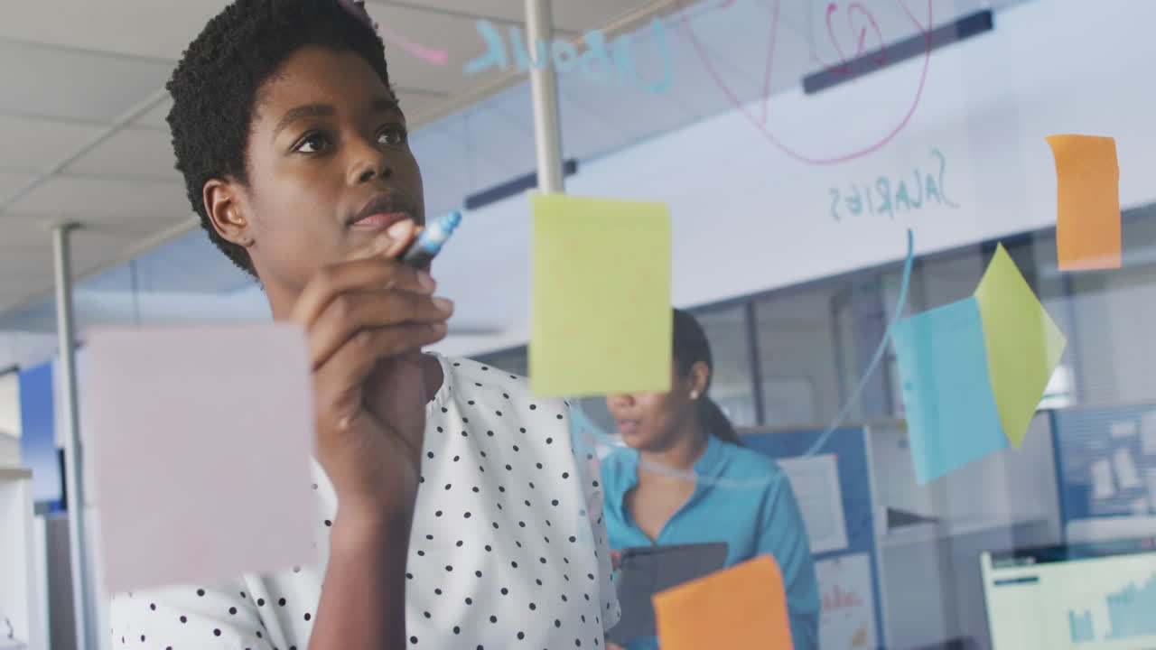 African american business people brainstorming and using tablet at office, slow motion