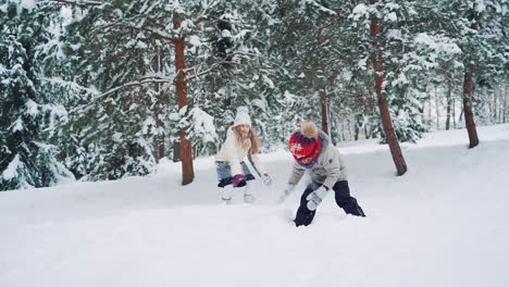 outdoor family fun on christmas vacation. boy and girl play snowballs. winter clothing. slow motion.