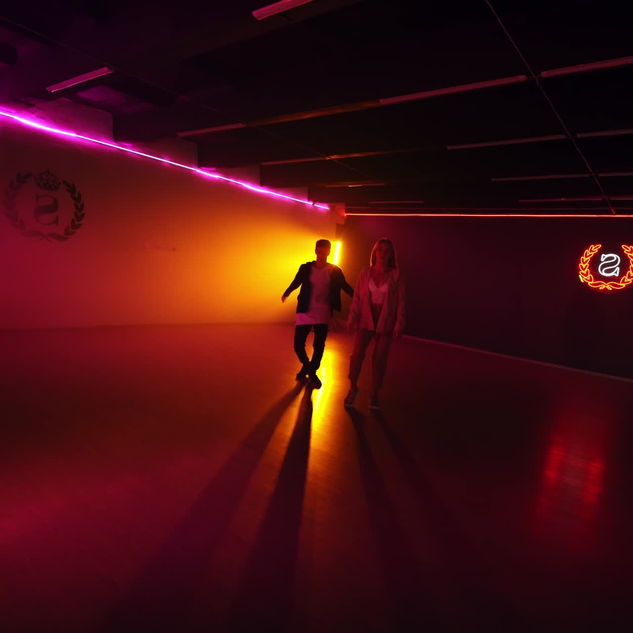 Talented dancers making perfomance in dark. Modern dancing couple in studio