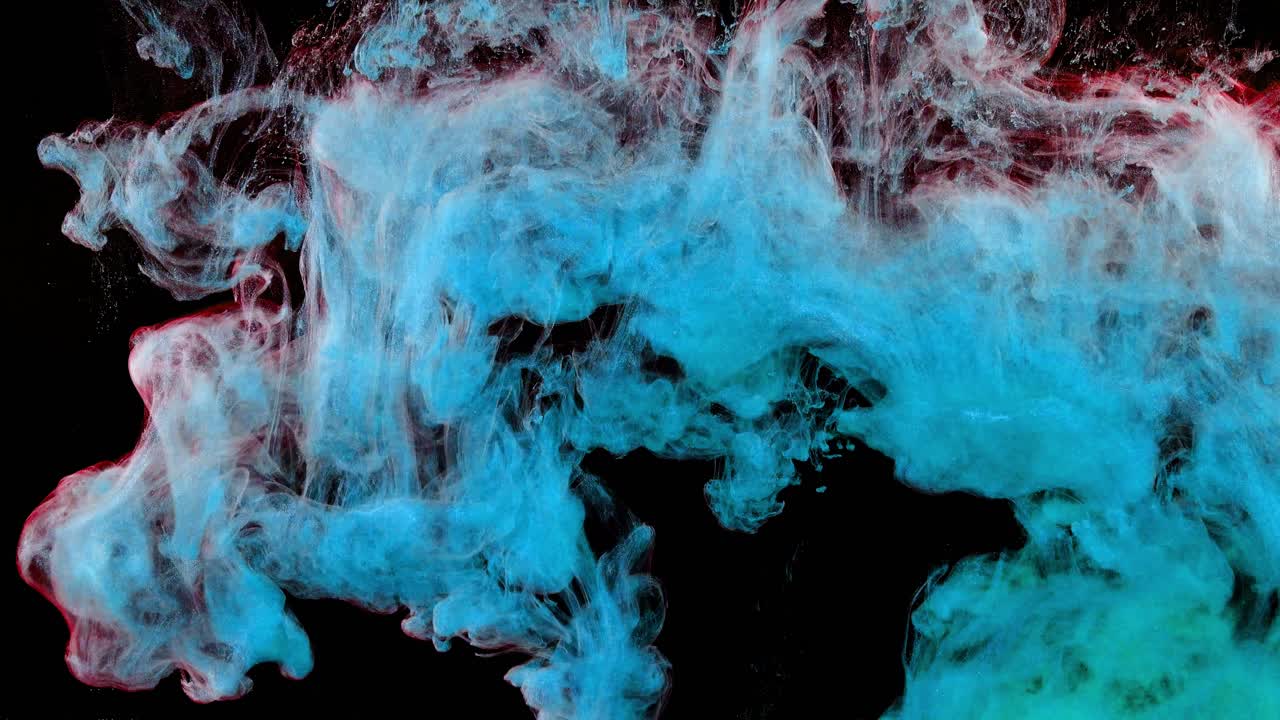 Abstract forms. Shooting on a black background. Mixing of paints