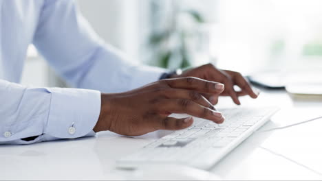 Hands,-keyboard-and-a-business-man-typing