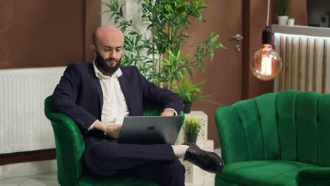 investor reviews notes on laptop