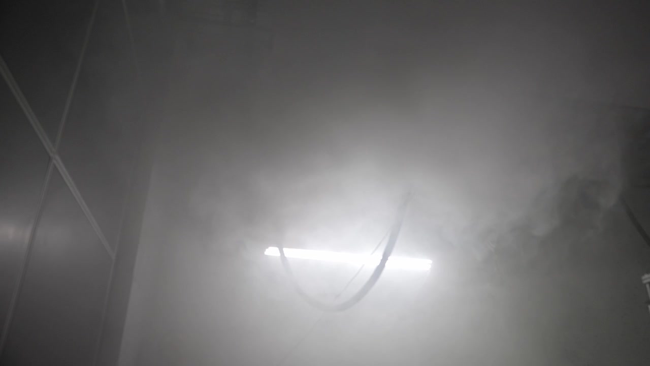 Fog filling an interior space during a climate system test, creating a dense, atmospheric vapor transition for visual effects and environmental simulation.