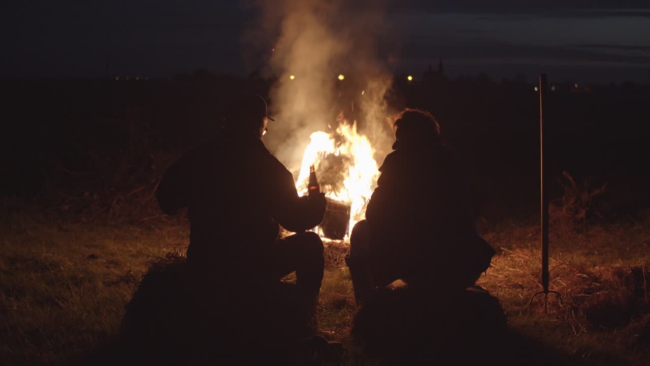 Big Campfire Conversation of 2 Men, Dark Night
