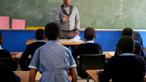 male teacher teaching students in the class 4k