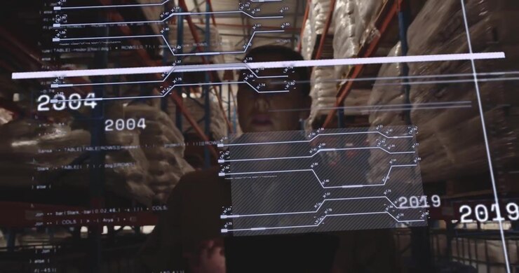 Warehouse analyst raising tablet and tapping display showing hologram timeline analyzing year data