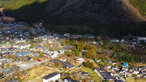 scenic aerial flight towards lake kinrinko in yufurin, japan