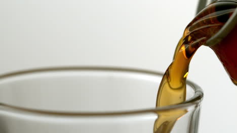 soda pouring from a can into a glass