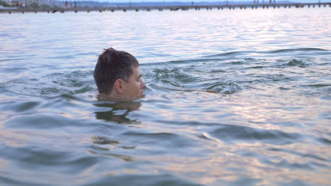 Boy-Swimming-in-the-Sea-with-Parents