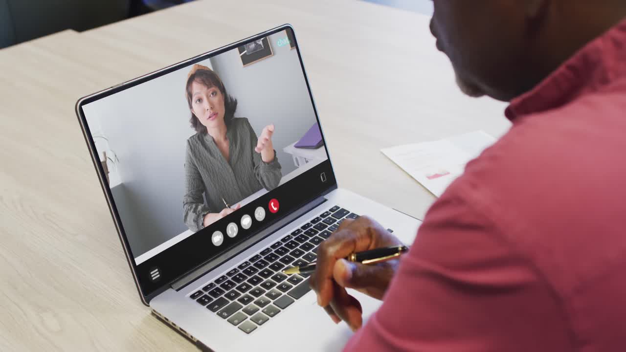 African american man using laptop for video call, with business colleague on screen