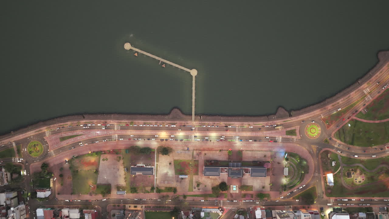 Top-down aerial view of the 4th section of Posadas waterfront with pier and traffic, Misiones, Argentina