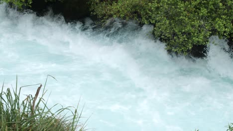 slow motion of the aggressive river leading up to huka falls in new zealand