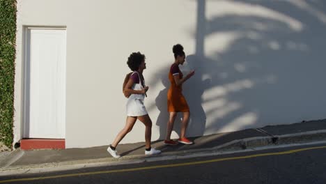 Two-mixed-race-women-walking-on-street