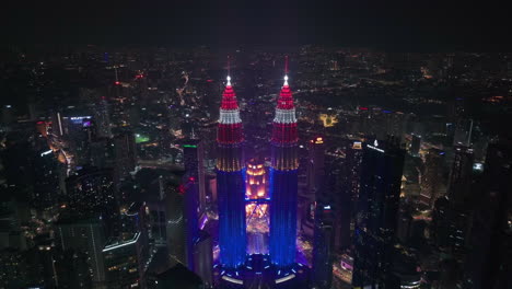 establishing drone shot of the petronas towers, independence night in malaysia