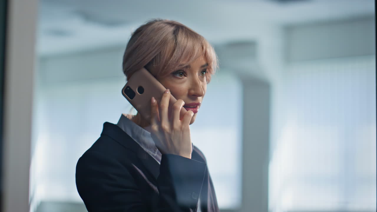 Stressed manager arguing cellphone shouting inside glass meeting room closeup