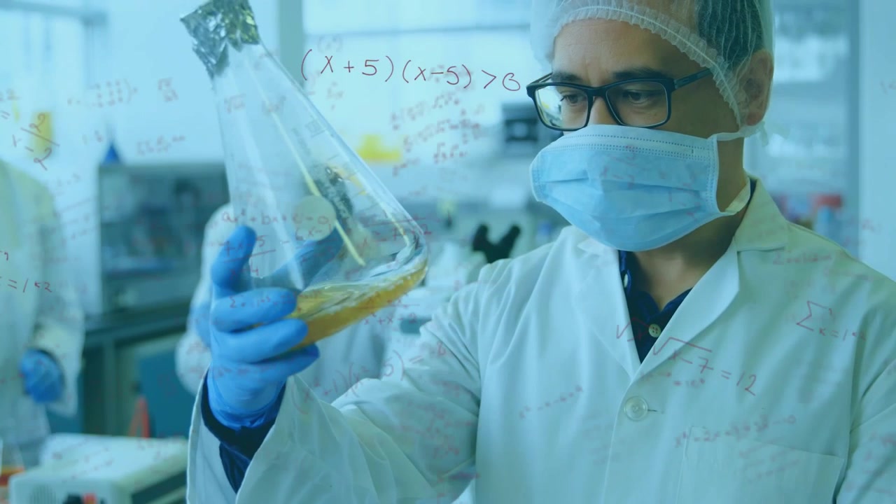 Gloved hand lifting flask, scientist inspecting and rotating flask to check amber liquid clarity