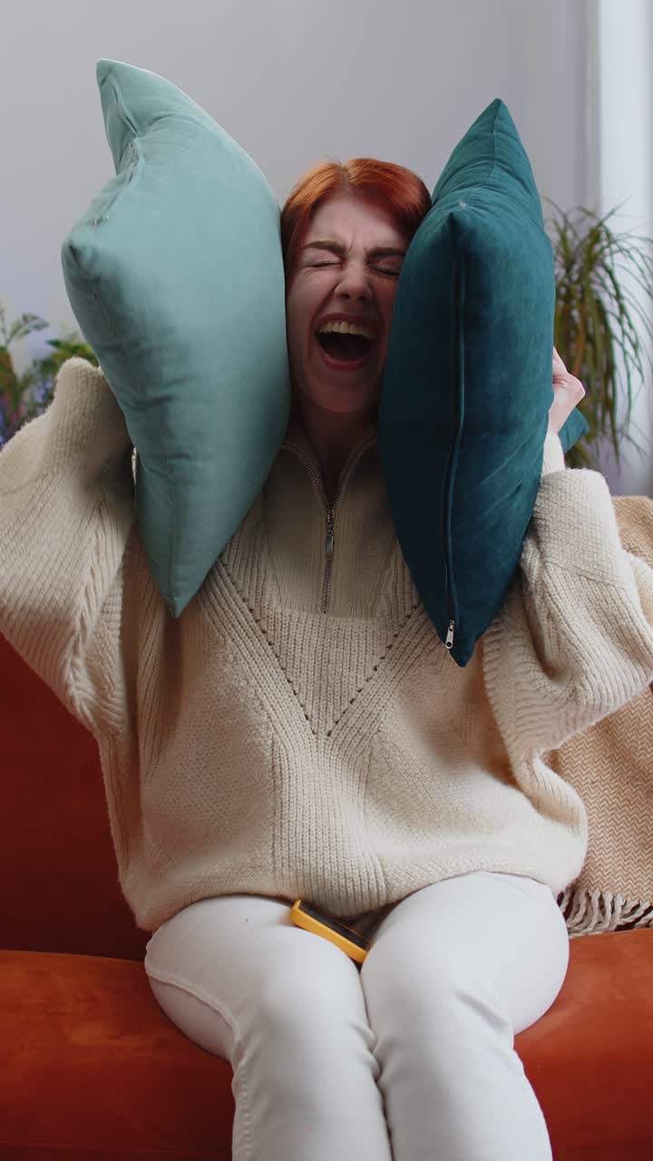 Repair work at neighbours concept irritated woman at home cover ears with pillows annoyed by noise