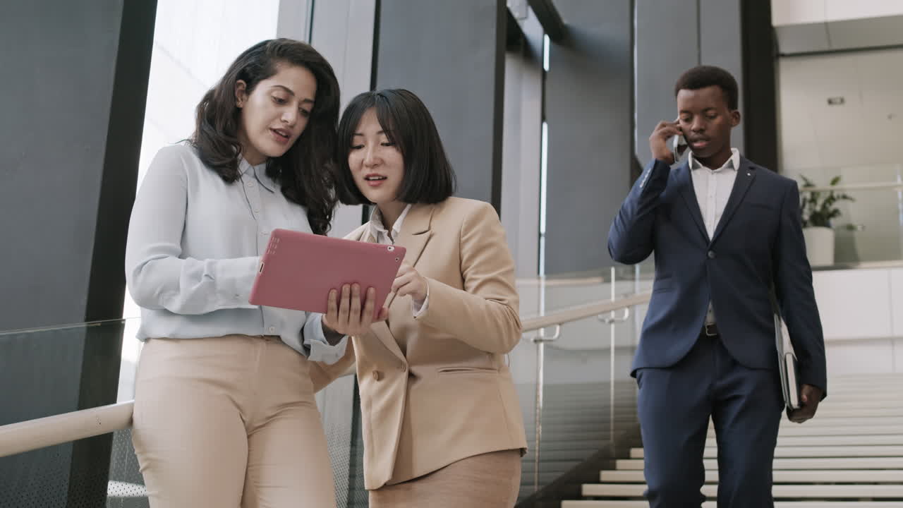 Businesspeople Using Gadgets in Office