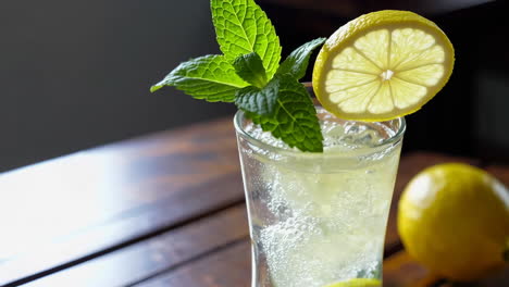 refreshing lemonade with mint and lemon on a wooden table