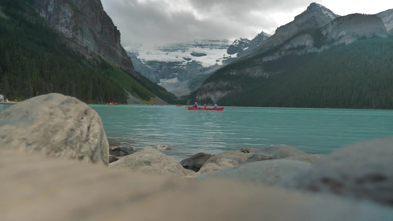 Epic Shot of Canoe floating on Lake Louise in Banff, Alberta.