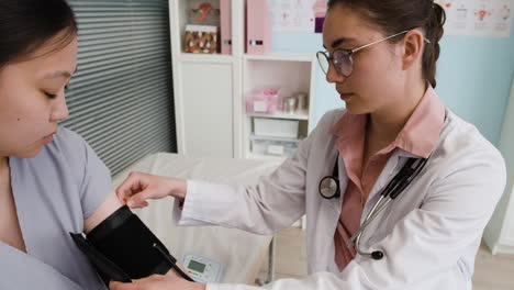 a doctor checking a patient's blood pressure