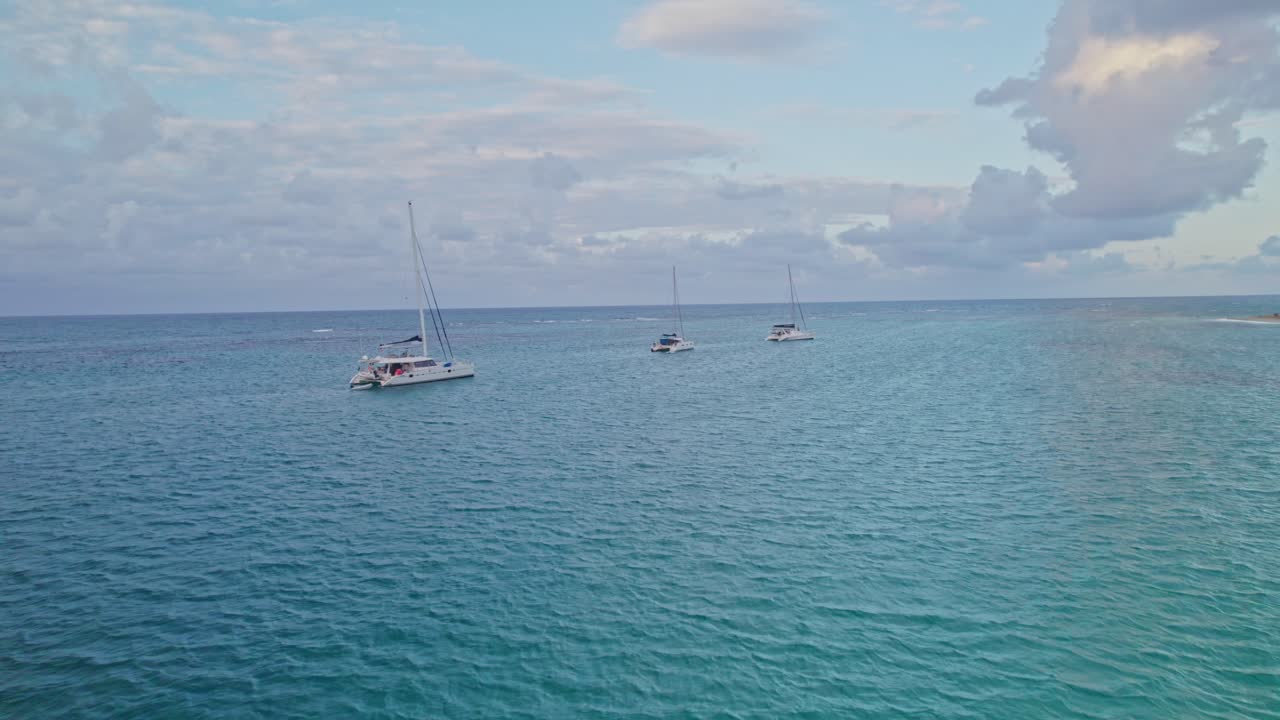 catamaranes turísticos anclados revelando el atardecer en las aguas cristalinas de la república dominicana