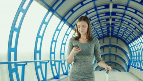 Young-Business-Woman-With-Travel-Bag-Arrives-At-The-Terminal