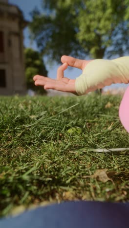 person meditating outdoors in a park