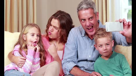 Glückliche-Familie,-Die-Ein-Selfie-Auf-Der-Couch-Macht