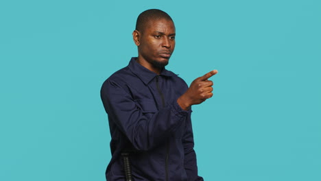 portrait of security guard pointing finger at intruder while overseeing premises