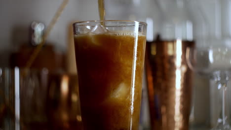 Fizzy-bubbly-soda-pouring-in-to-pint-glass-at-home-bar