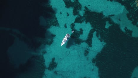 Yacht-boat-ship-sailing-at-pristine-turquoise-clear-water-beach-bay-on-Palma-de-Mallorca-Island