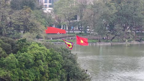 flags waving near a lakeside building