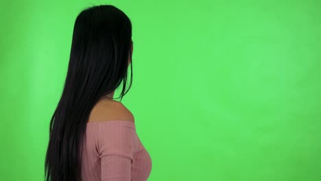 una joven asiática atractiva mira en la distancia - estudio de pantalla verde
