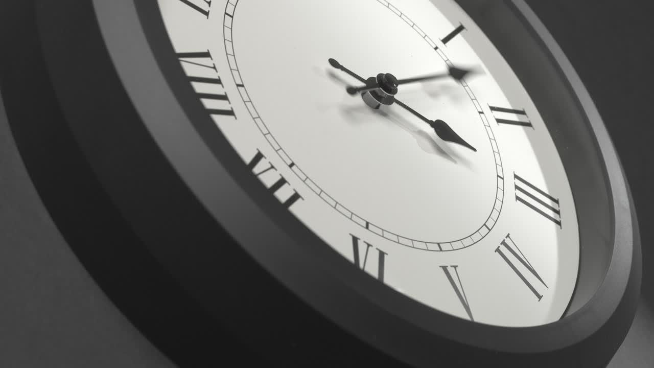Latin Clock Face in Time Lapse on Dark Grey Wall