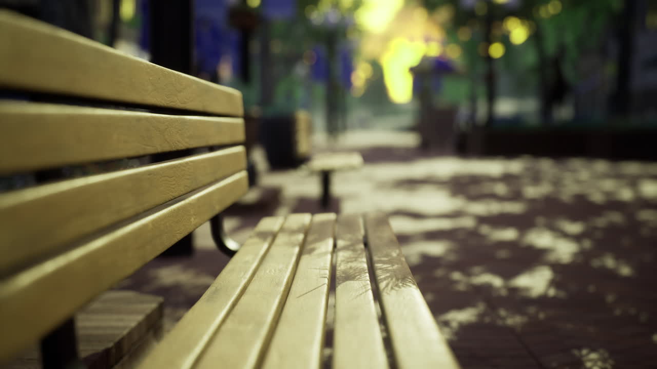 Wooden bench under dappled sunlight in a serene park setting during afternoon