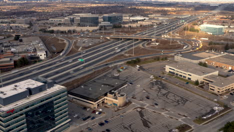 Aerial-hyperlapse-of-a-bustling-urban-area-with-highways-and-buildings-at-dusk