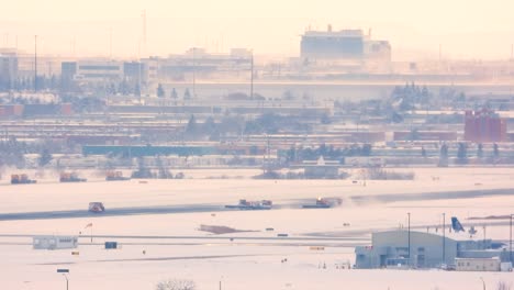 snow clearing in progress at toronto airport runway, wide angle shot