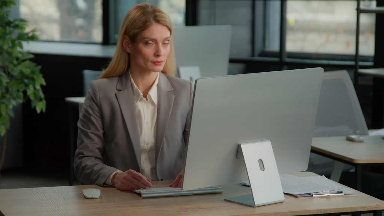 Businesswoman Working and Offering Handshake in Office