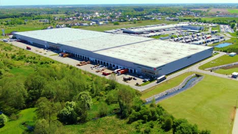 aerial view of warehouse storages or industrial factory or logistics center from above. top view of industrial buildings and trucks