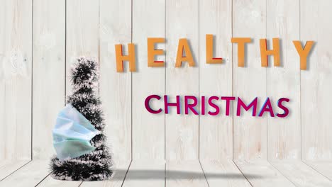 christmas tree in medical mask spinning around on wood