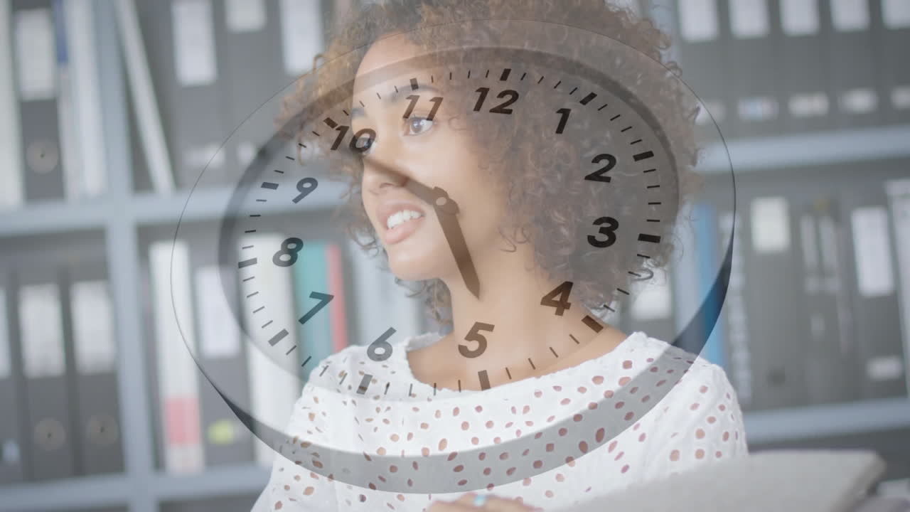 Animation of clock moving over biracial businesswoman talking in office