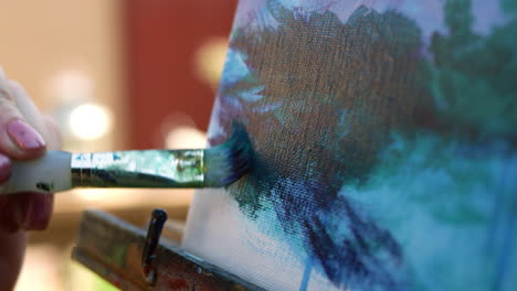 slow motion close up video of female artist painting on canvas