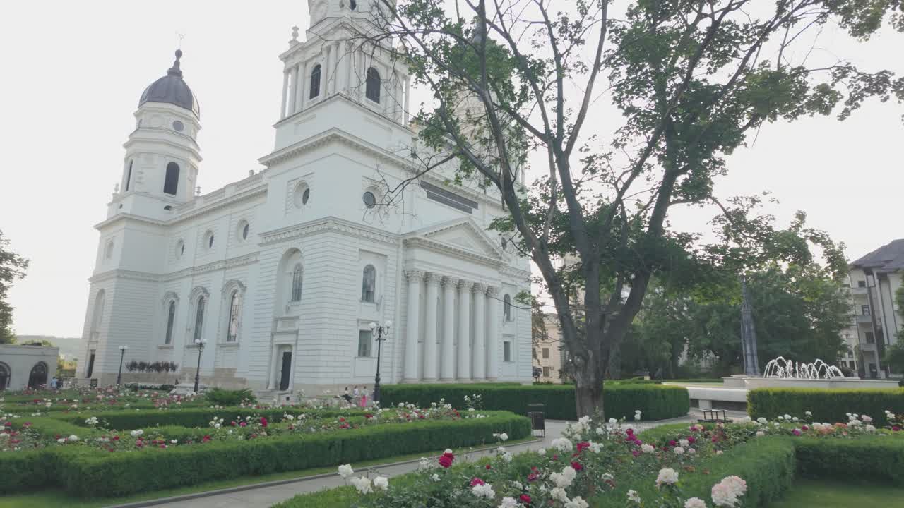 Catedrala Trei Ierarhi in Iasi at sunset, surrounded by a rose garden and fountain
